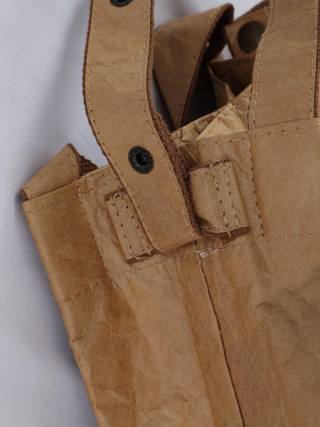 A close-up of TALISHKO's natural wrinkle kraft paper bag, focusing on brown strap details.