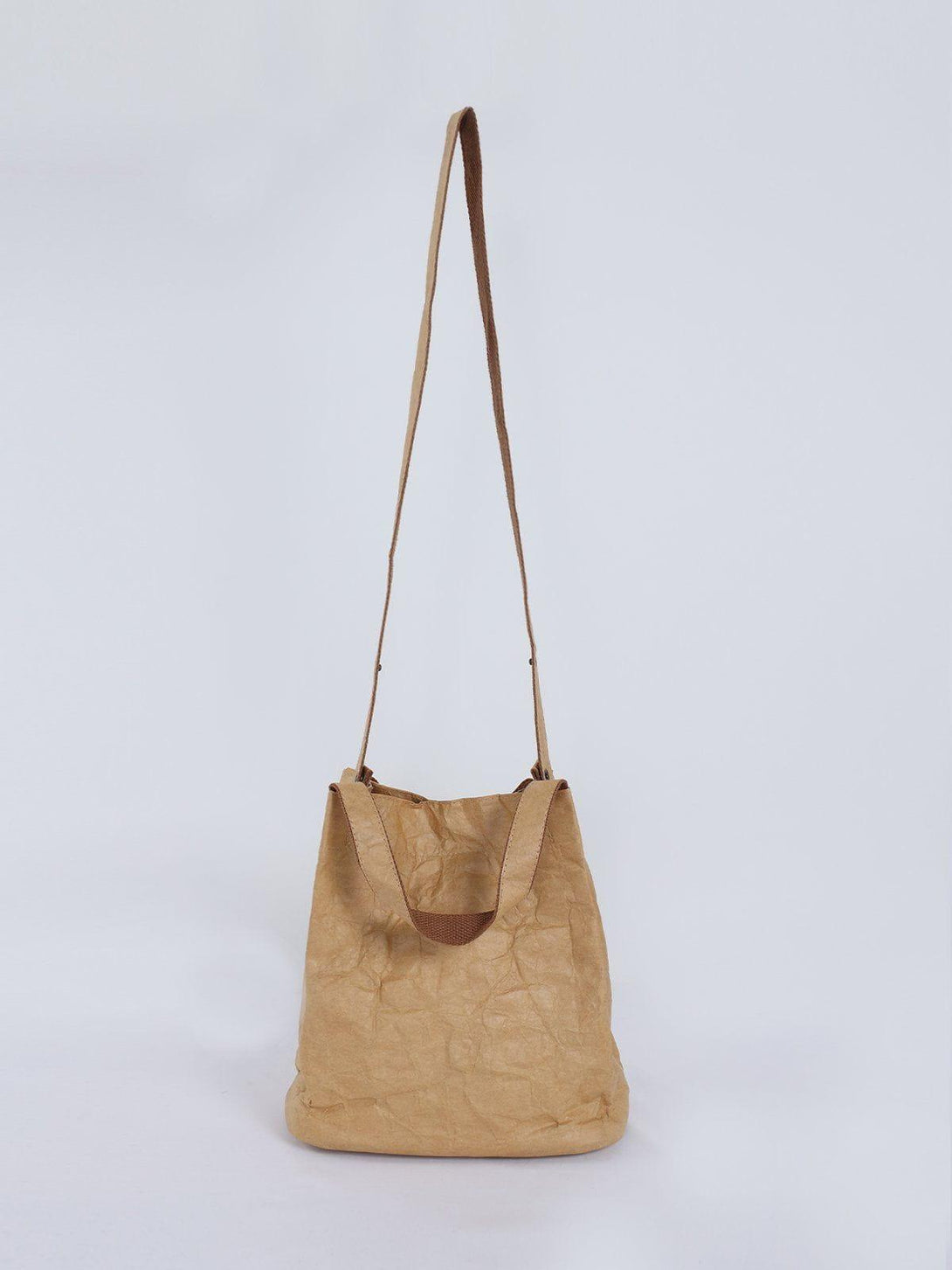 TALISHKO's natural wrinkle kraft paper bag with brown strap, showcasing a unique texture.