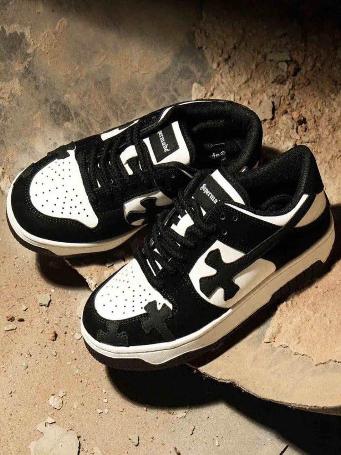 TALISHKO's Niche Board Casual Shoes in black and white, set against a textured background.