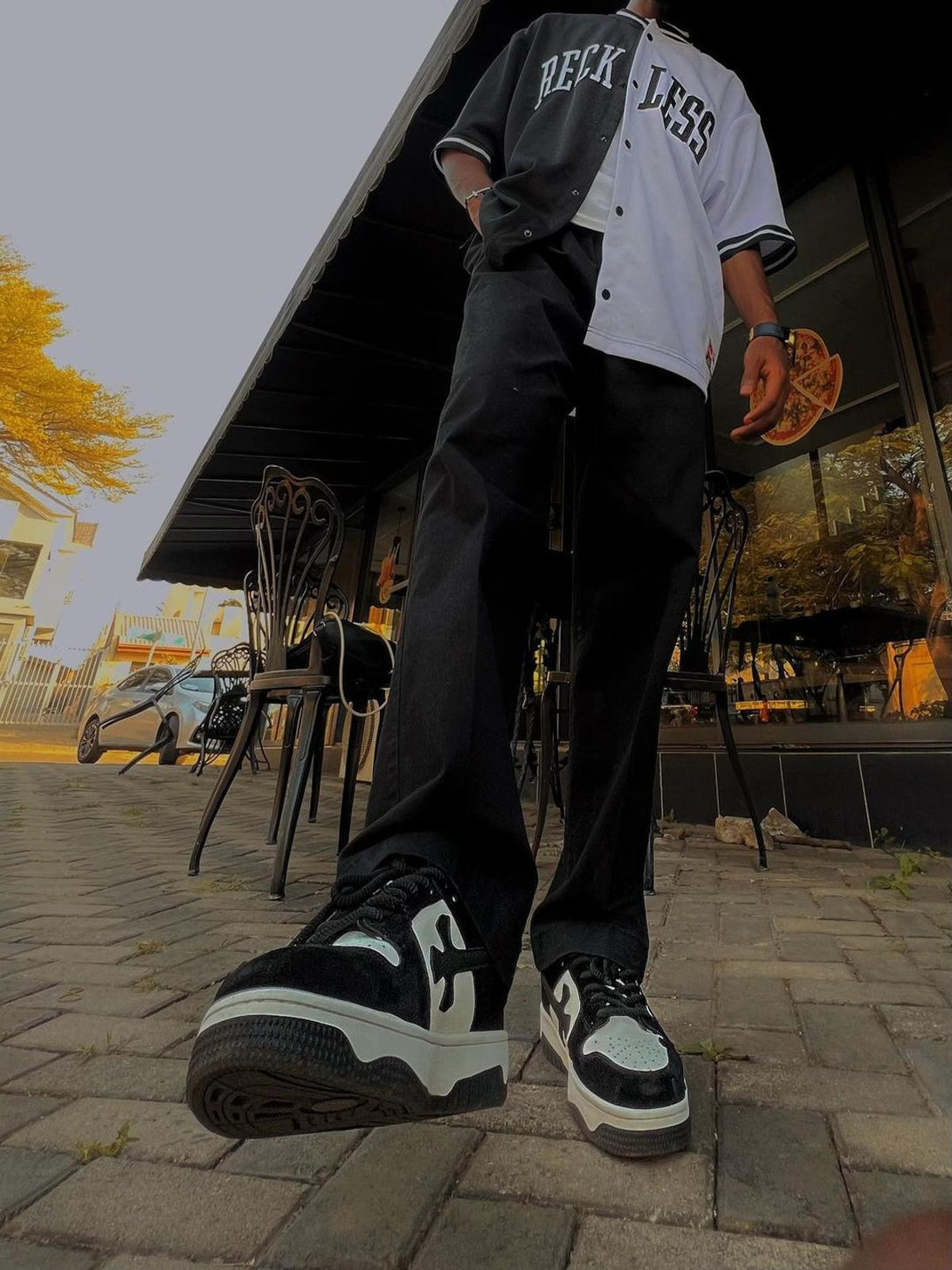 Model wearing TALISHKO's Niche Board Casual Shoes, showcasing a stylish streetwear look.
