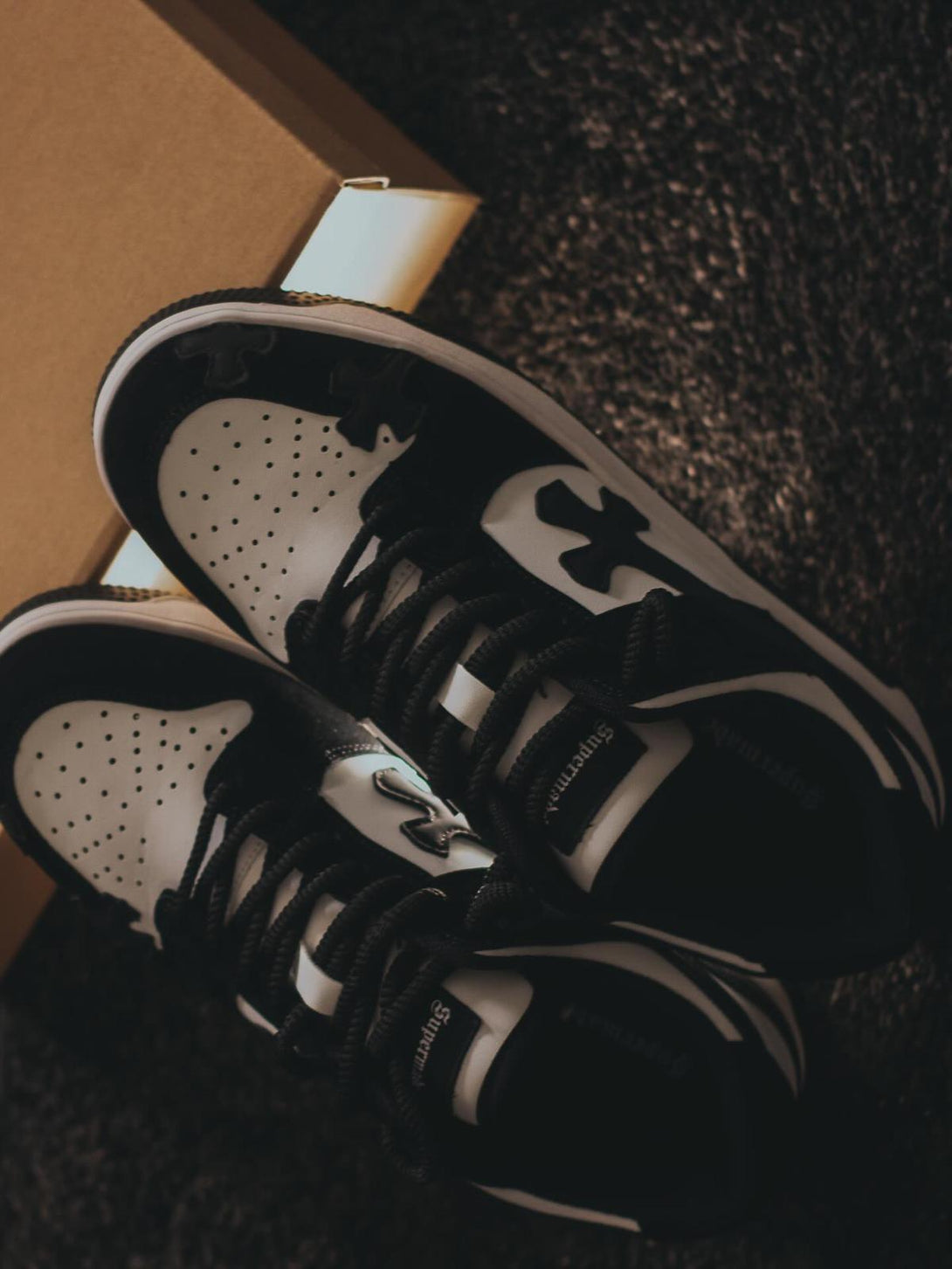 Black and white TALISHKO Niche Board Casual Shoes on a textured surface, showcasing paired style.