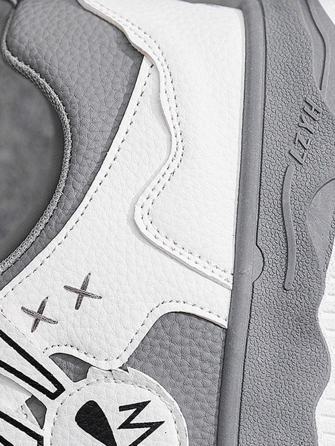 Zoomed-in texture of TALISHKO board shoes, featuring gray and white design elements.