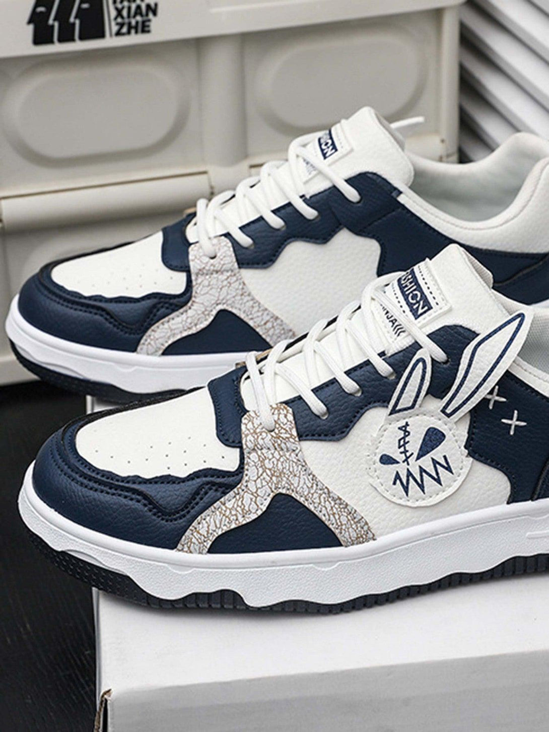 TALISHKO board shoes with blue and white graphic accents, offering a stylish and breathable design.