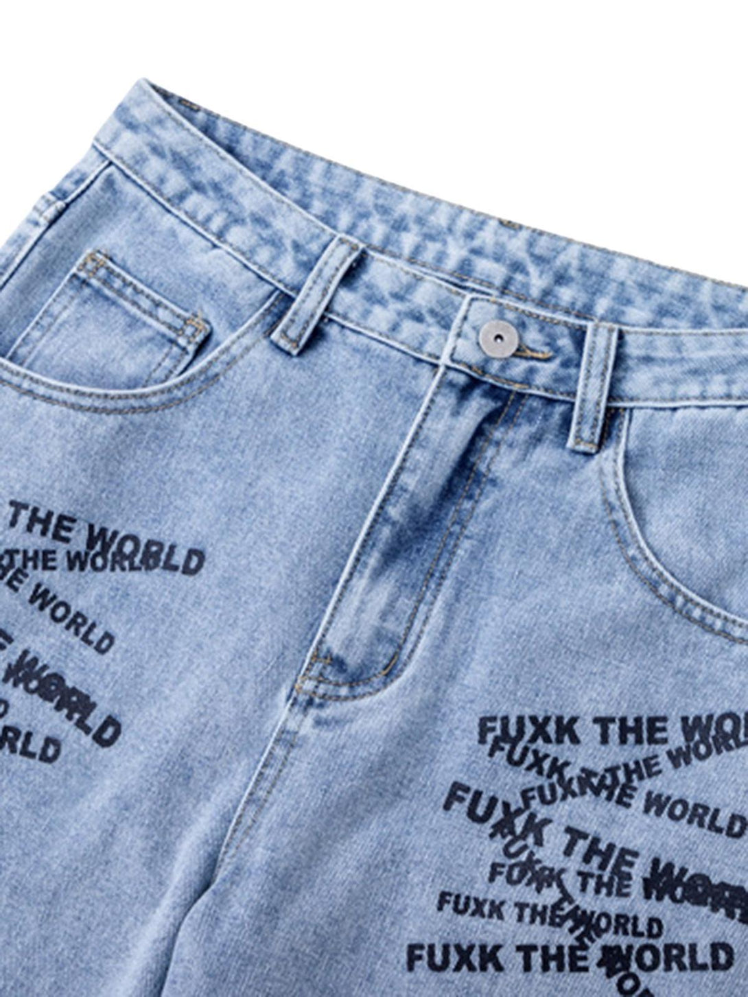 A detailed view of TALISHKO jeans featuring bold letter embroidery and tie-dye design.