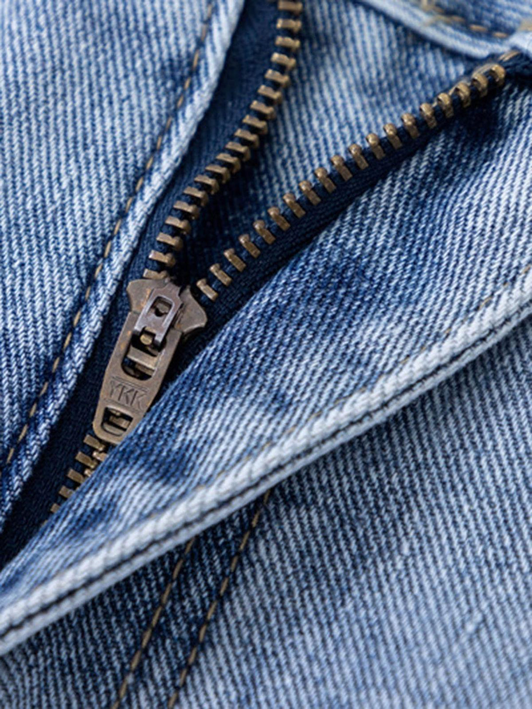 Intricate look at TALISHKO jeans zipper detail, featuring stylish tie-dye fabric and stitching.