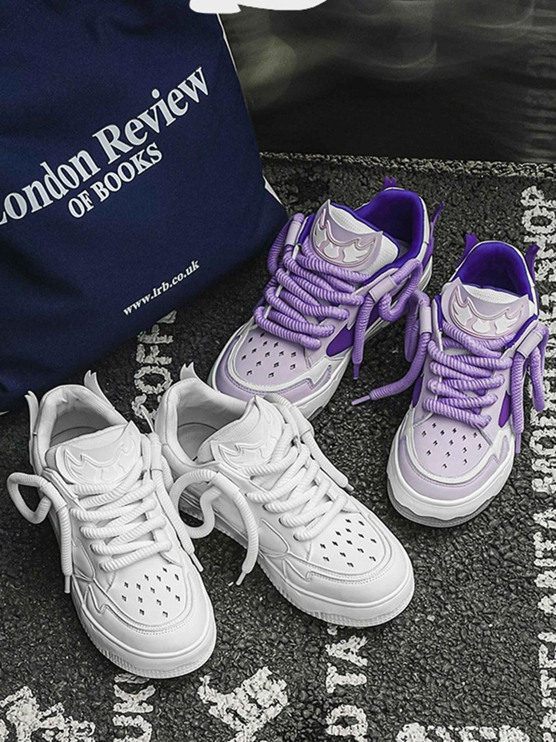 TALISHKO retro board shoes in white and purple, featuring bold laces and unique design elements.