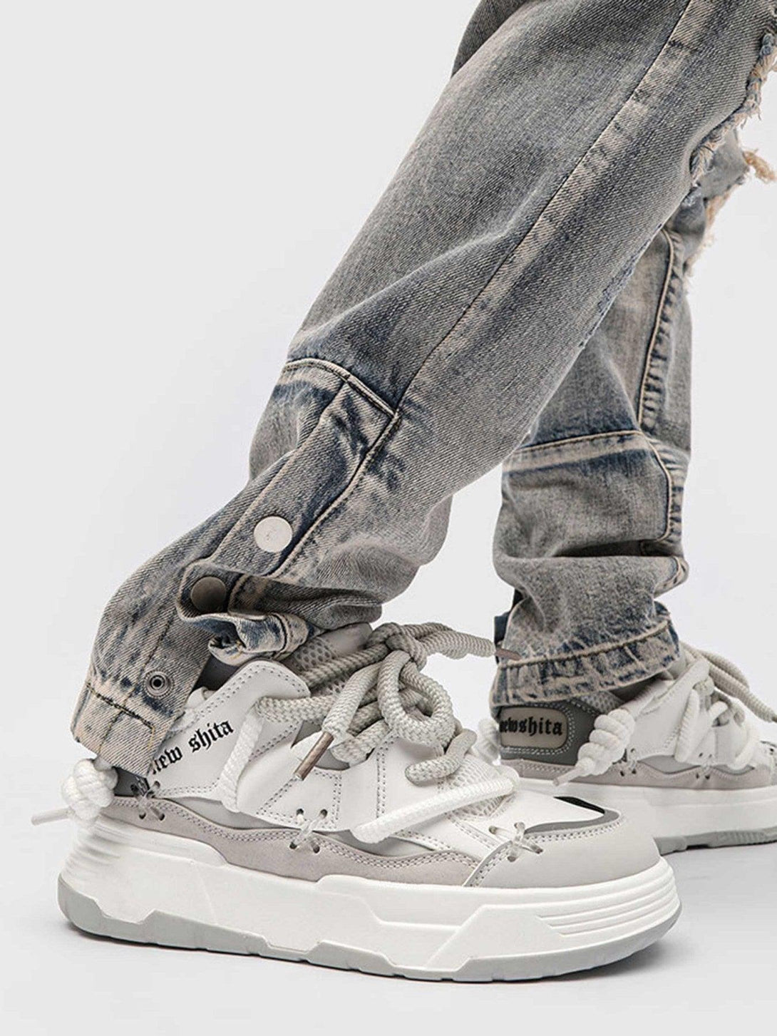 Close-up of TALISHKO thick-soled board shoes paired with distressed denim for a stylish look.