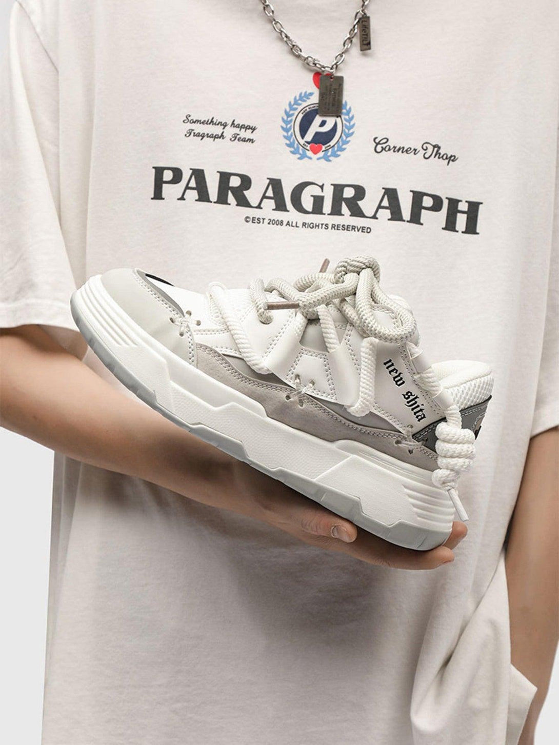 TALISHKO board shoes with thick soles, shown in hand, perfect for trendy streetwear looks.