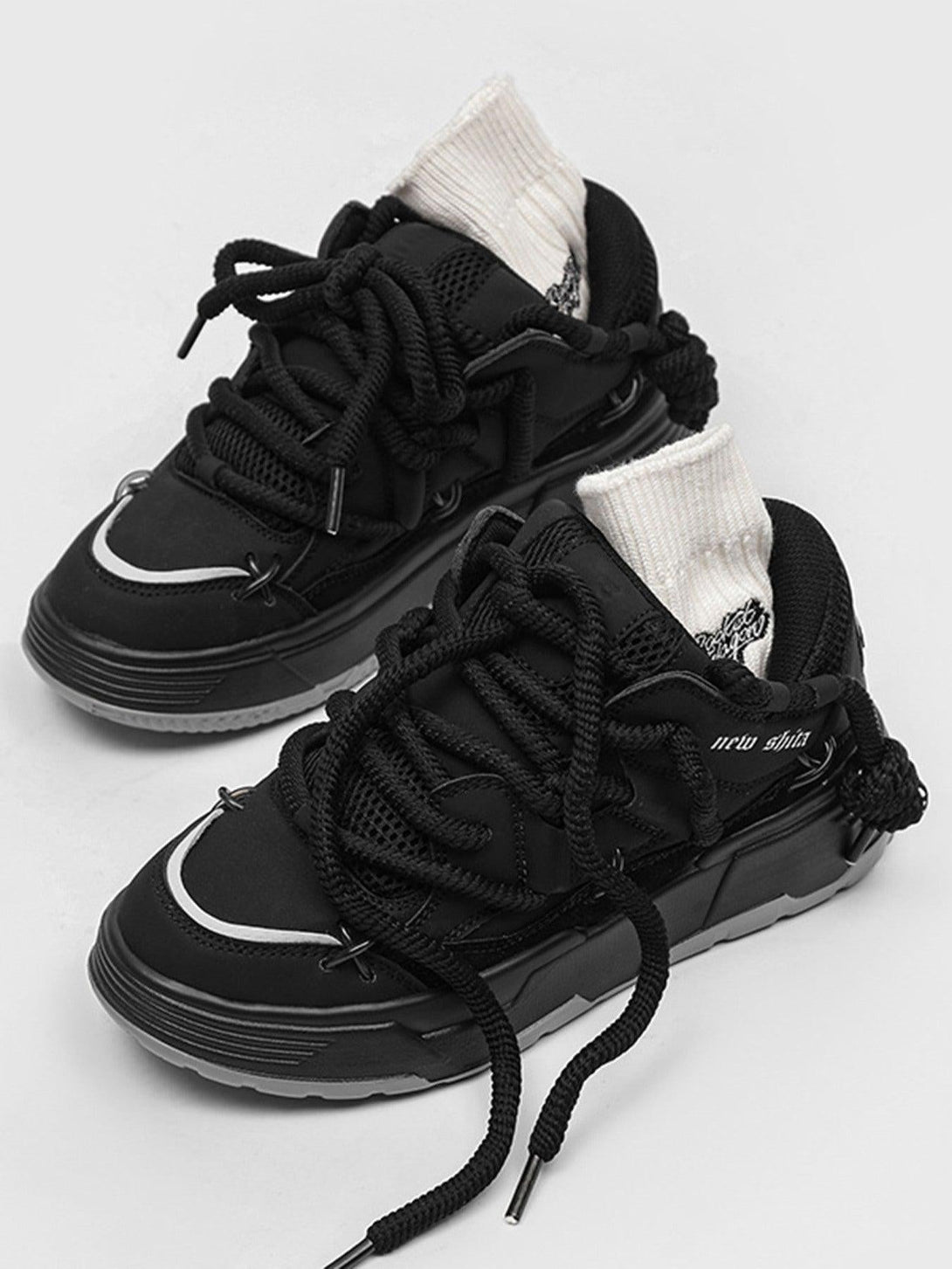 TALISHKO black board shoes with thick soles and chunky laces, paired with white socks.