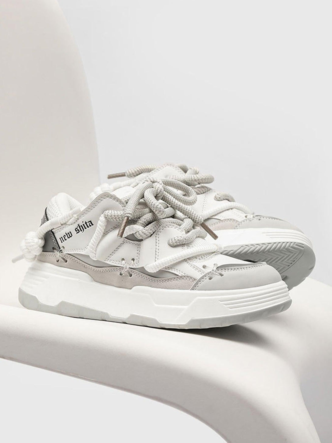 Trendy white board shoes by TALISHKO with thick soles, ideal for casual streetwear looks.