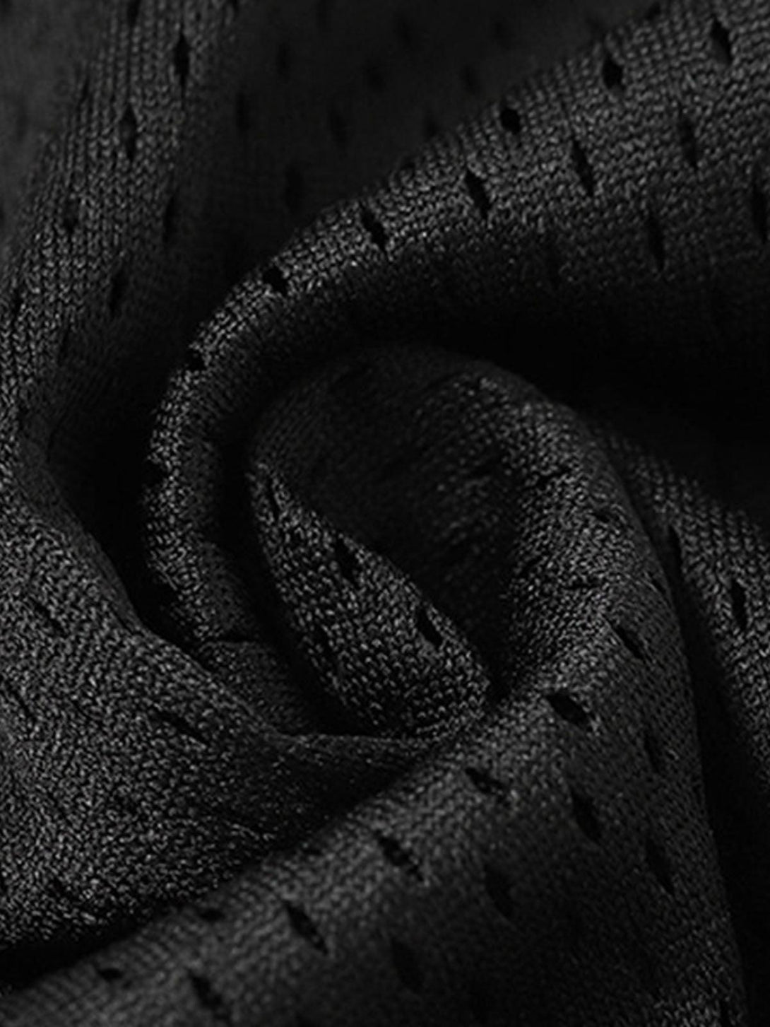 Detailed fabric and stitching of TALISHKO's black jersey, showcasing its breathable texture.