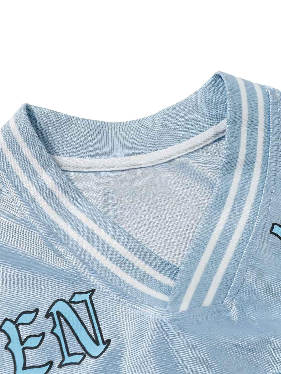 Intricate look at the V-neck collar and striped design of TALISHKO's light blue jersey T-shirt.