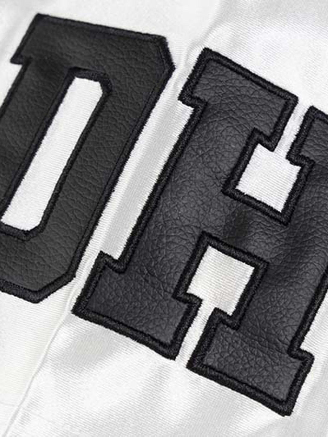 Detailed fabric and stitching on sports jersey T-shirt showcasing bold letters by TALISHKO.