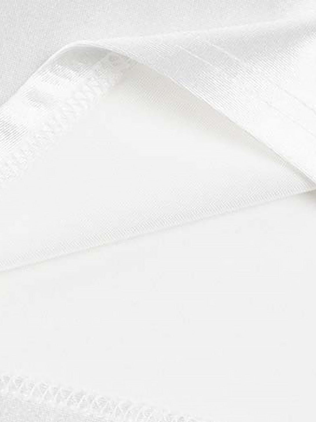 Intricate look at white fabric and stitching detail on a TALISHKO sports jersey T-shirt.