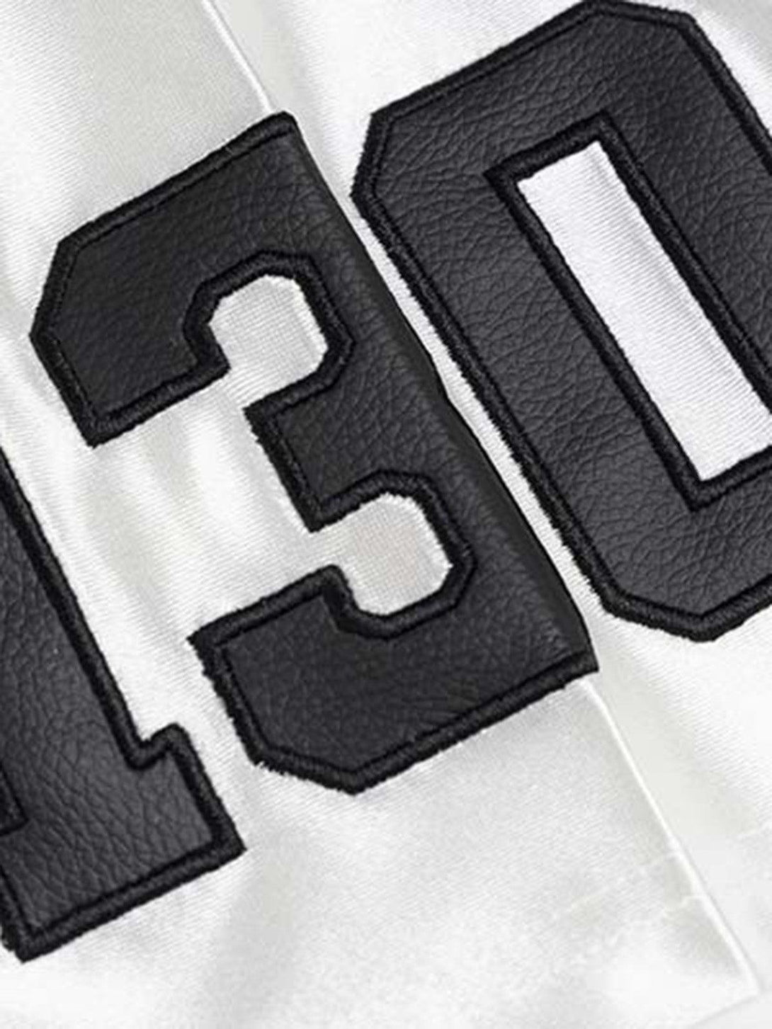 A detailed look at the number "130" print on a sports jersey T-shirt by TALISHKO.
