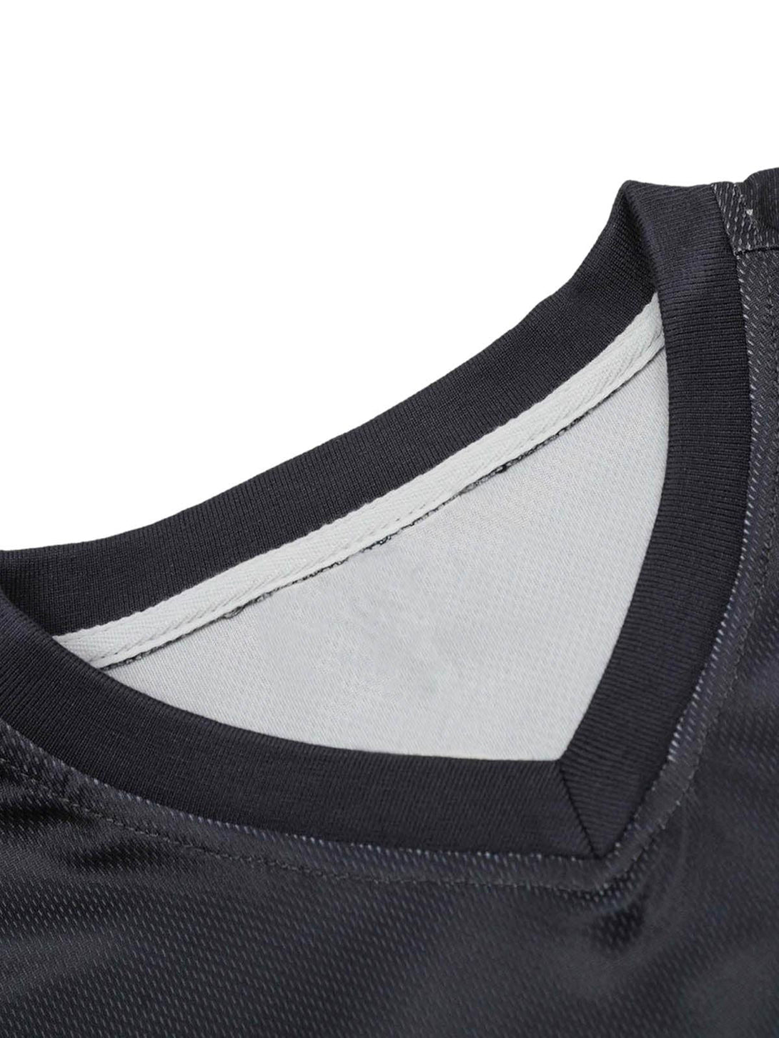 A detailed look at the collar and stitching of a black sports jersey T-shirt by TALISHKO.