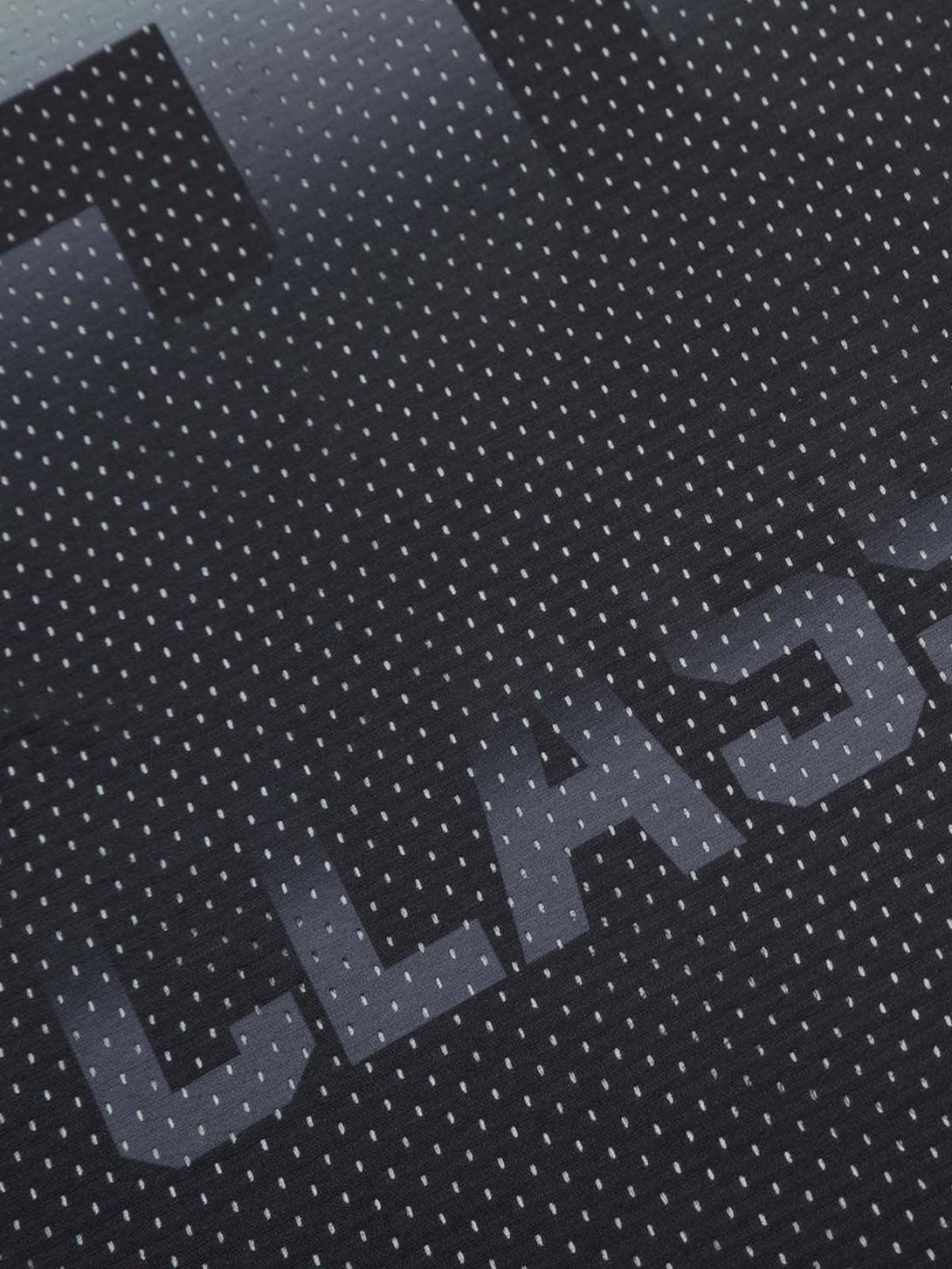 Intricate look at the textured pattern on TALISHKO sports jersey T-shirt featuring "CLASSIC" print.