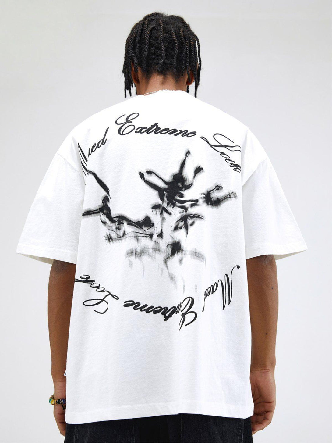 Back view of TALISHKO white graphic tee with artistic monster print and dynamic script design.