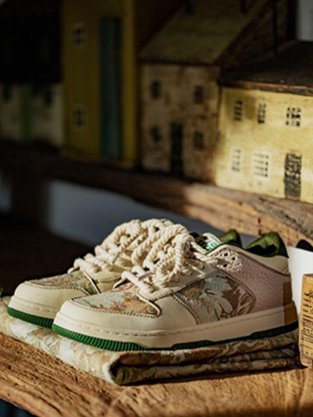 TALISHKO skate shoes with oil painting forest print, displayed on a rustic wooden surface.