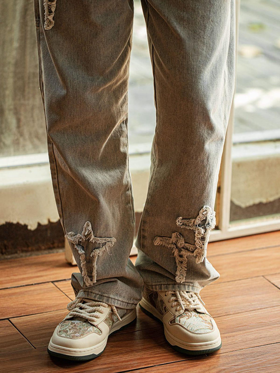 TALISHKO skate shoes paired with distressed gray jeans, showcasing a casual, artistic style.