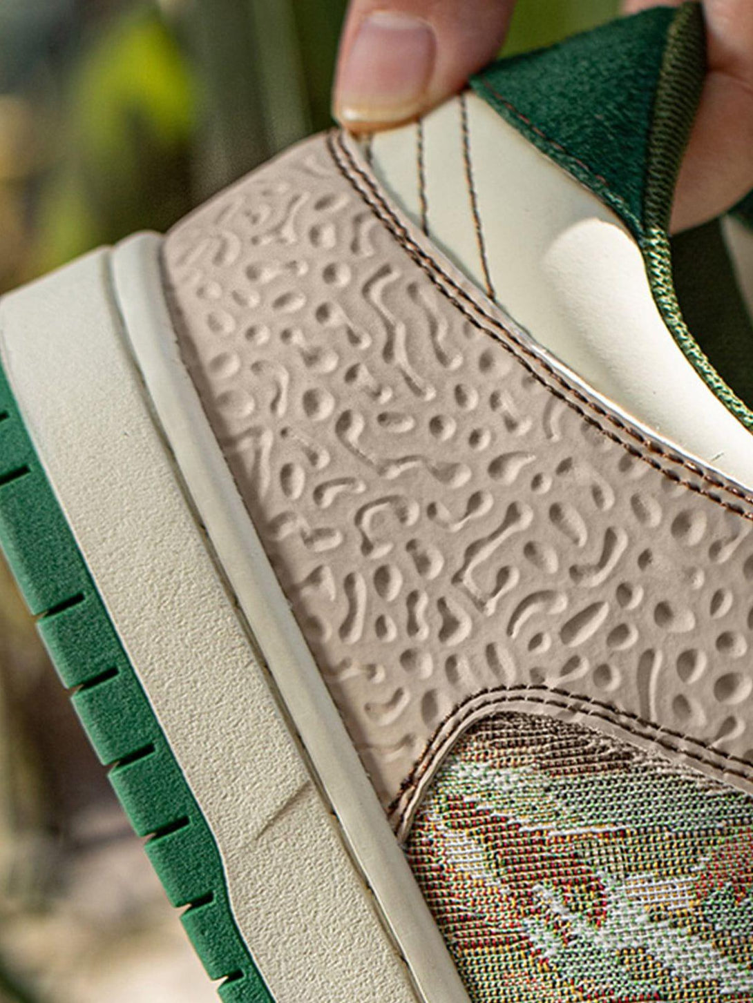 Intricate look at TALISHKO skate shoes, highlighting textured details and forest-inspired print.