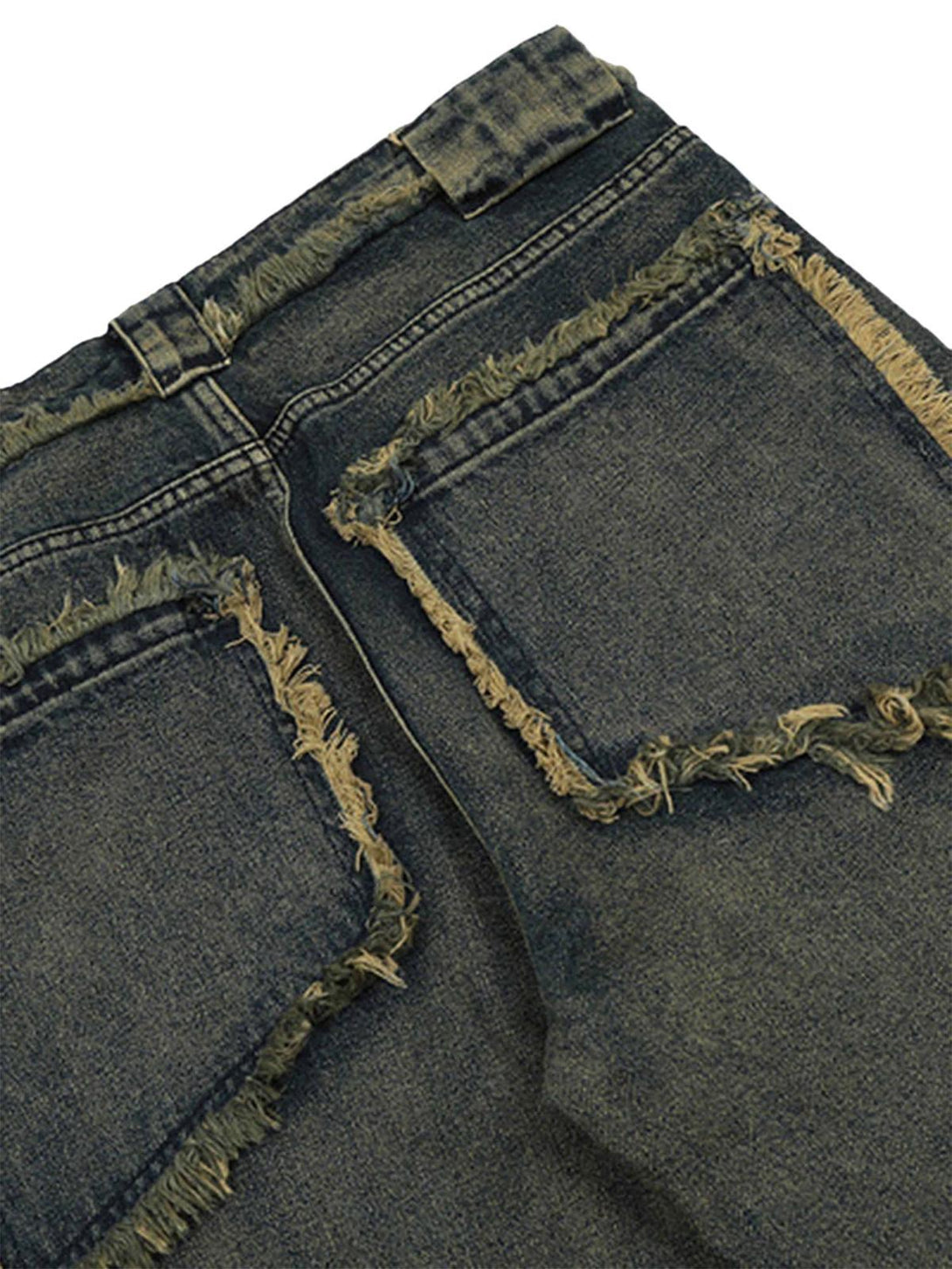 Frayed back pockets on TALISHKO jeans, highlighting raw hem and distressed denim style.