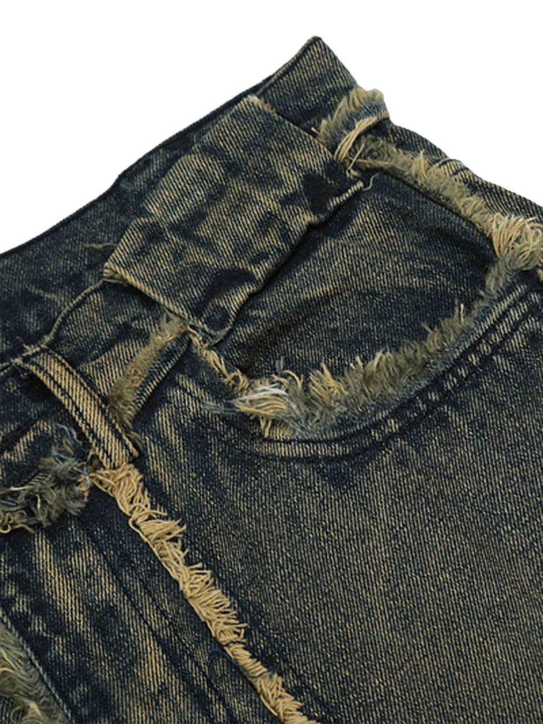 A detailed view of TALISHKO jeans shows frayed edges and raw hem for a trendy, distressed look.