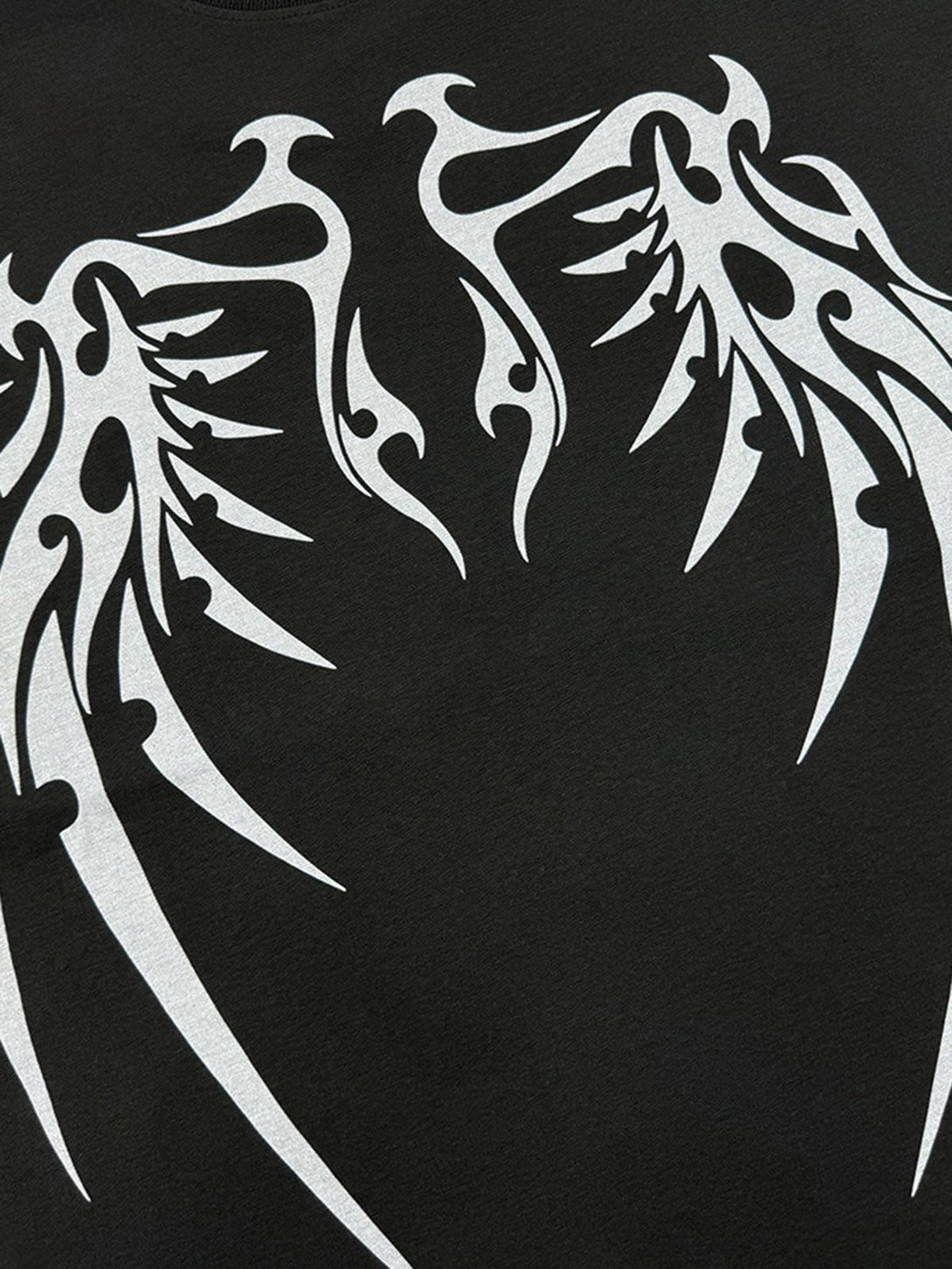 Close-up of a bold bone wing design on a street rap T-shirt by TALISHKO, capturing edgy style.