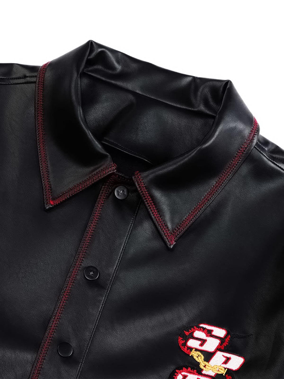 Detailed fabric and red stitching on TALISHKO's embroidered leather shirt.