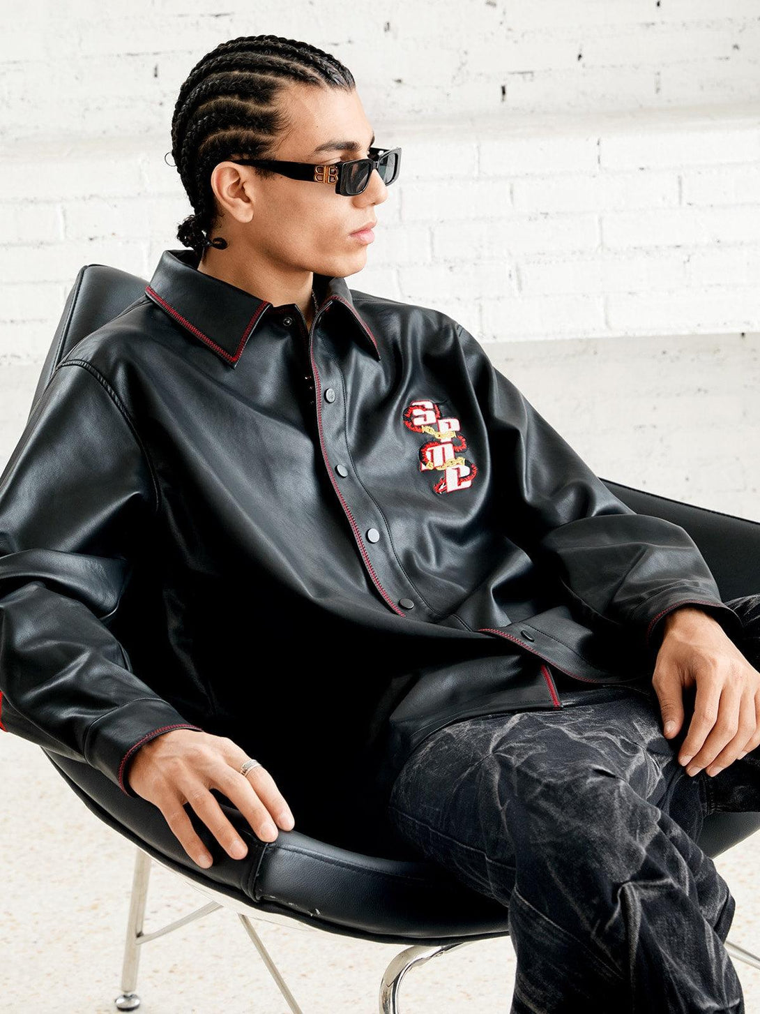 Model in TALISHKO's leather shirt with standout embroidery, exuding contemporary style.