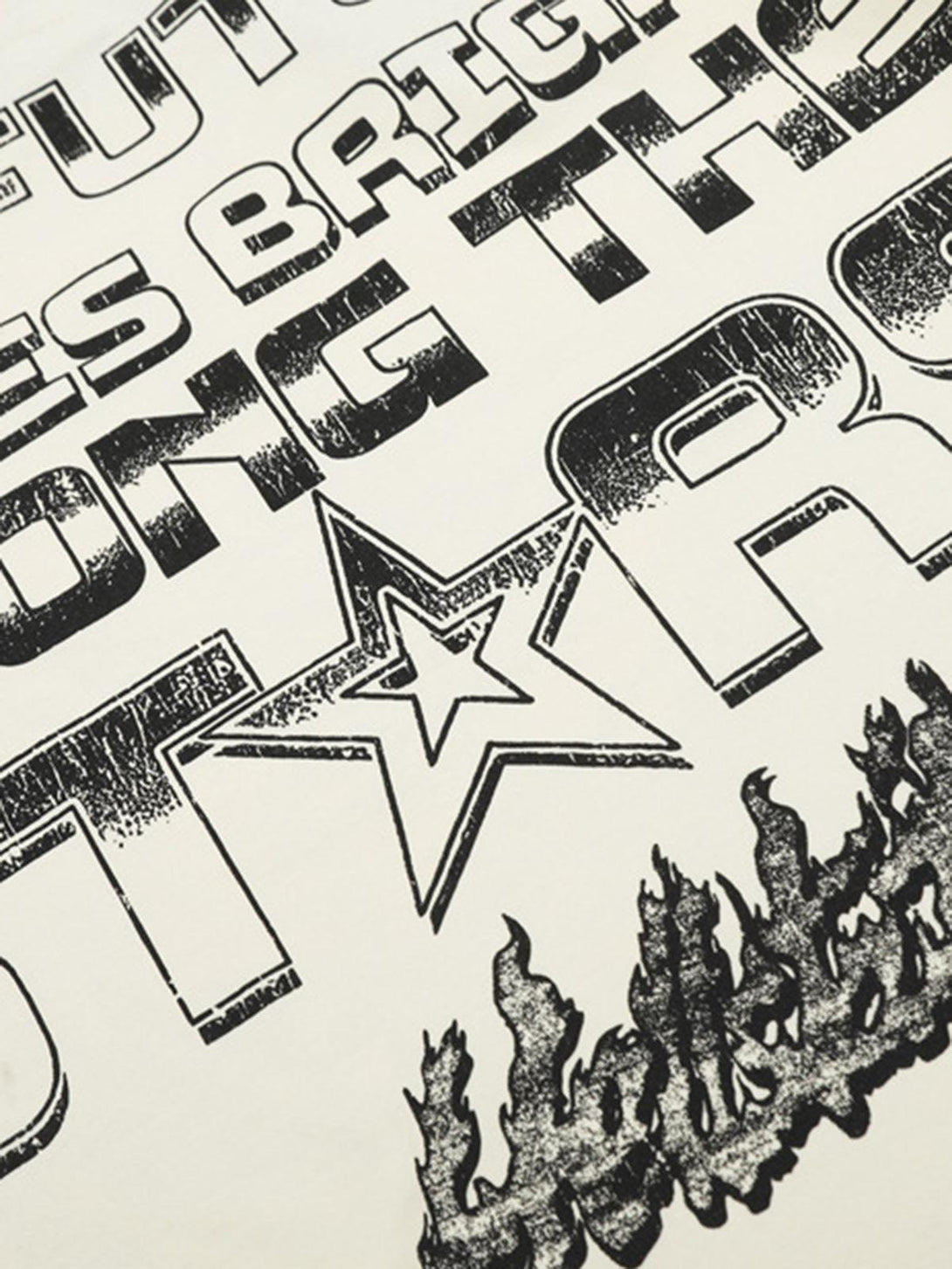 Zoomed-in texture of TALISHKO's inspirational T-shirt, highlighting bold lettering and star design.