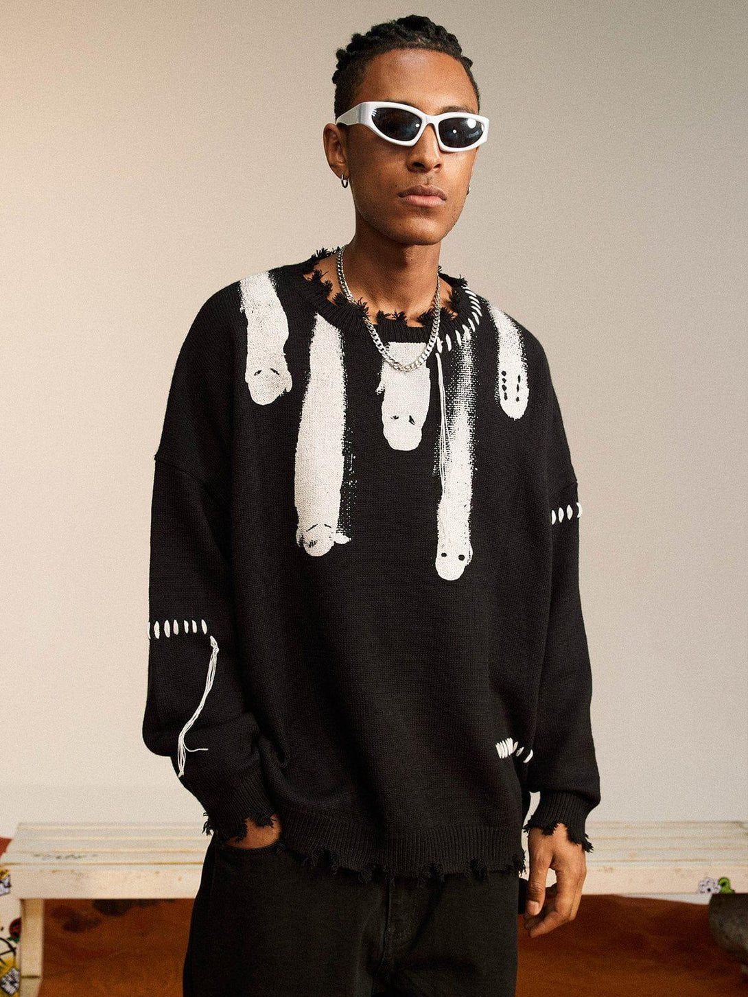 Model in TALISHKO "Out Of Body" knit sweater with unique abstract design and frayed edges.