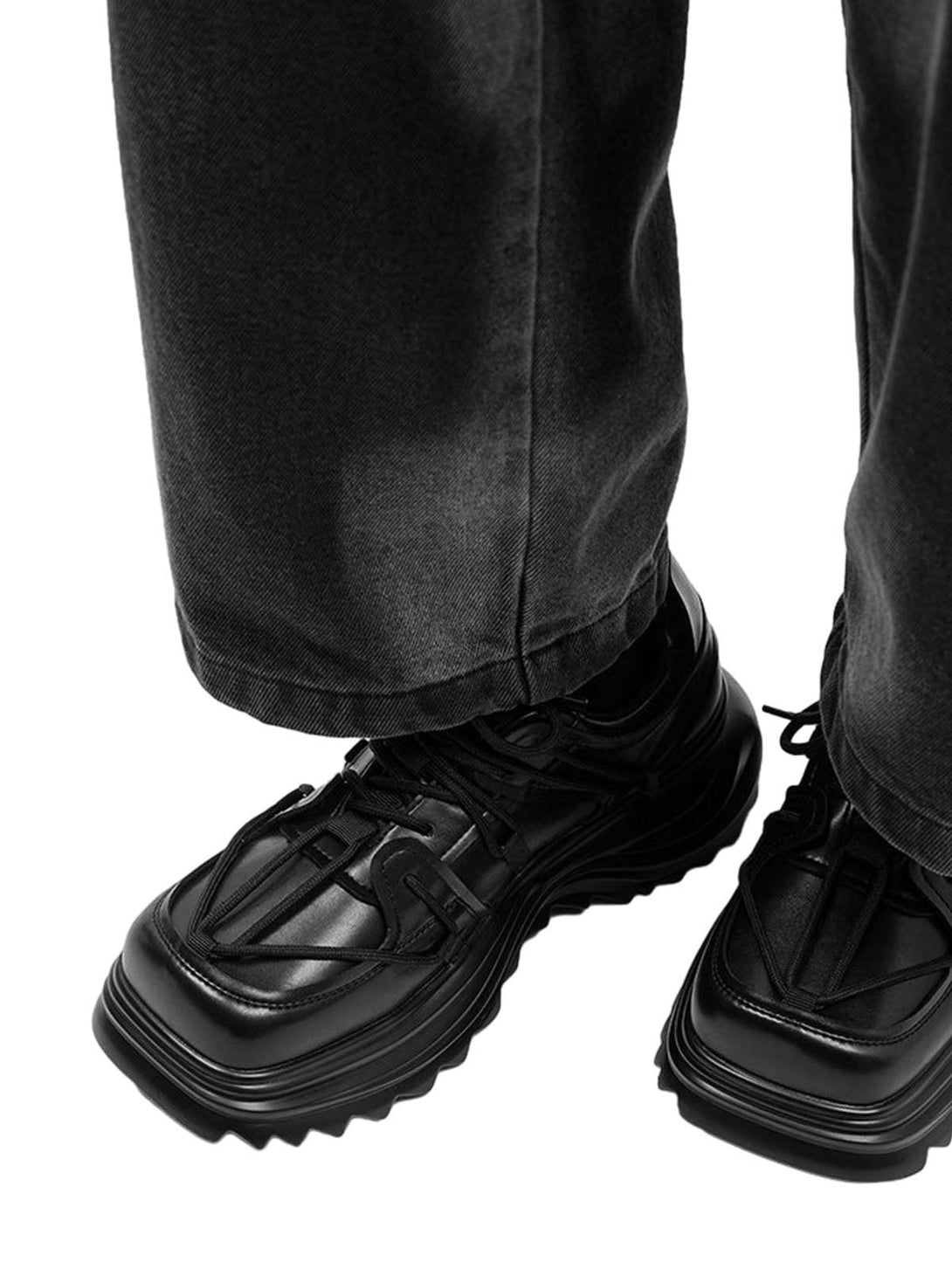TALISHKO black platform sneakers styled with dark jeans, showcasing modern workwear vibes.