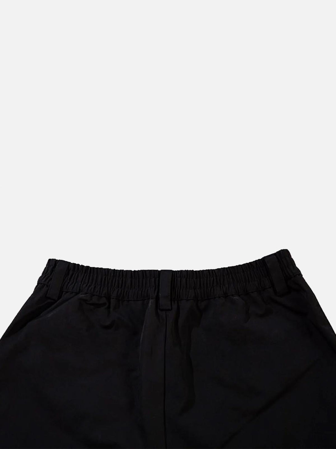 A close-up of TALISHKO sweatpants, highlighting the elastic waistband and sleek black fabric.