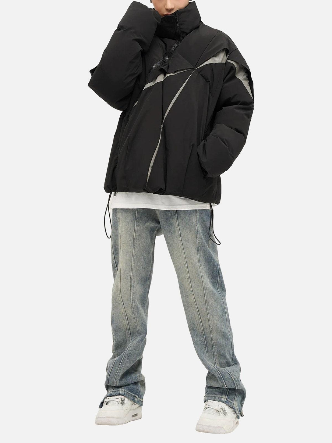 Model wearing a black oversize deconstructed cotton jacket by TALISHKO, paired with jeans.