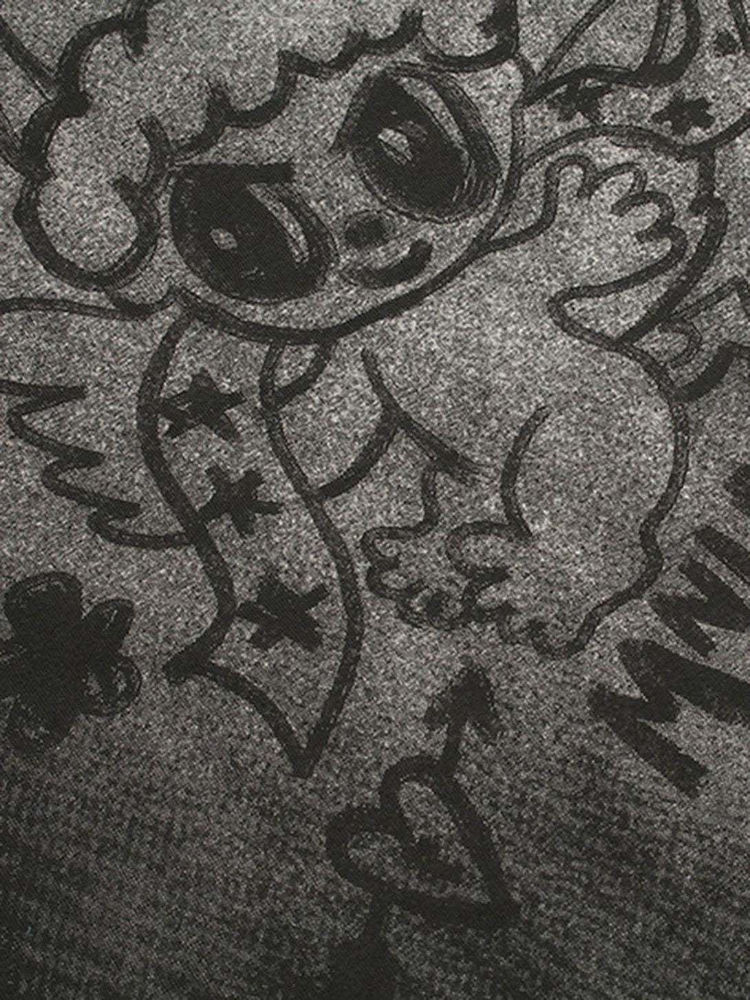 Intricate look at TALISHKO's oversized angel graphic on T-shirt, highlighting playful design.