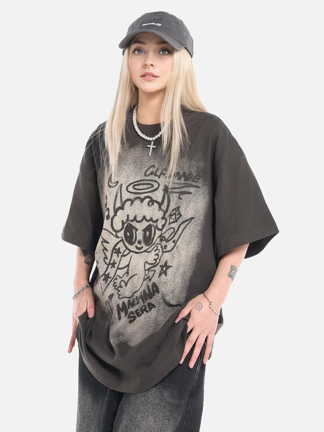 Model wearing TALISHKO oversized angel graphic T-shirt with playful design and accessories.