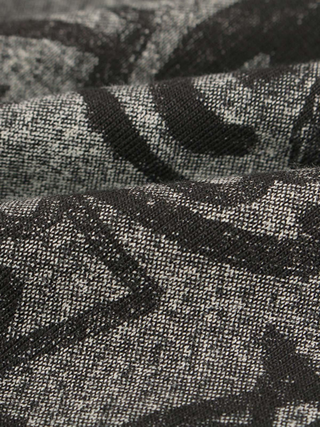 "Texture and pattern showcased in TALISHKO's oversized angel graphic T-shirt design."