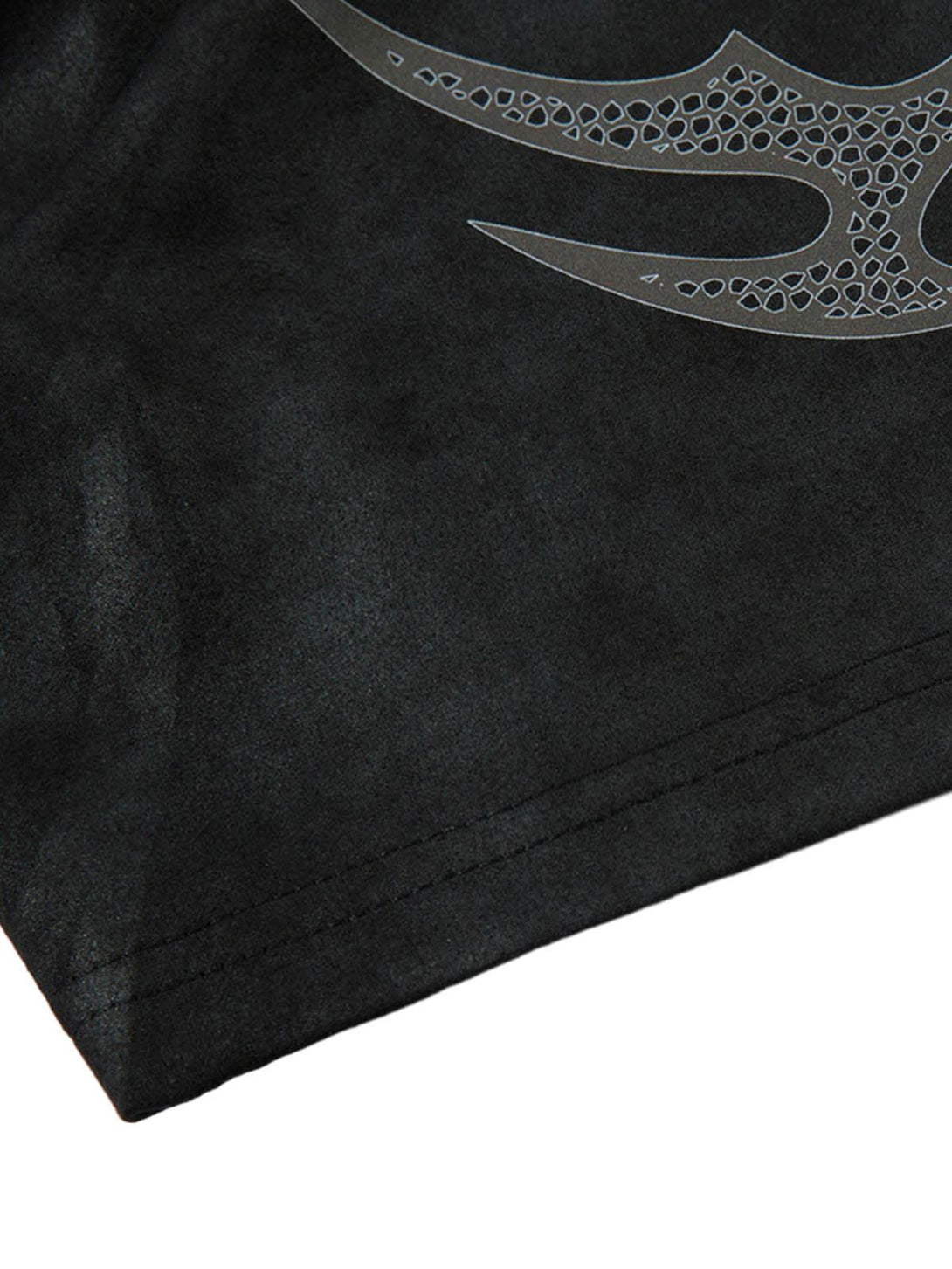 Intricate look at the graphic design on a black suede t-shirt by TALISHKO, highlighting texture.