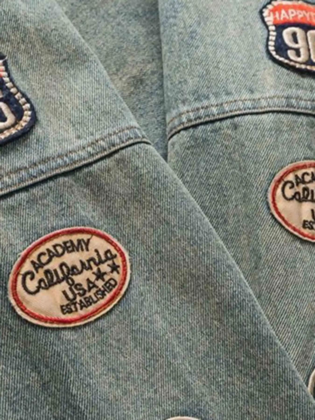 Close-up of embroidered patches on TALISHKO's oversized hip-hop denim jacket.