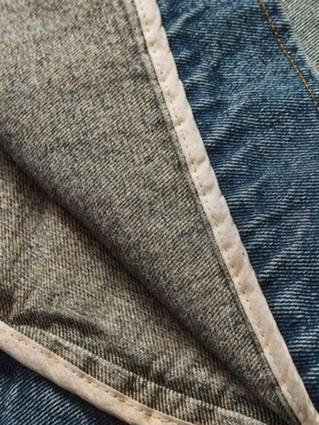 Intricate look at TALISHKO's denim jacket lining, highlighting quality stitching and texture.