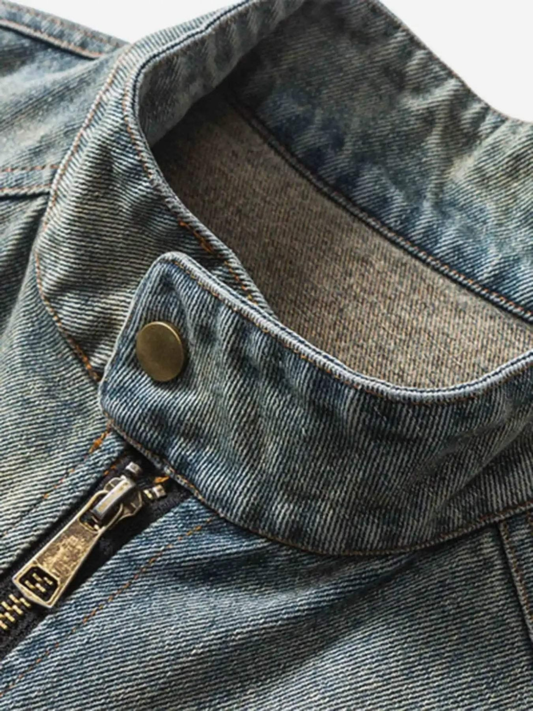 Focusing on the collar and zipper detail of TALISHKO's denim jacket, highlighting rugged texture.