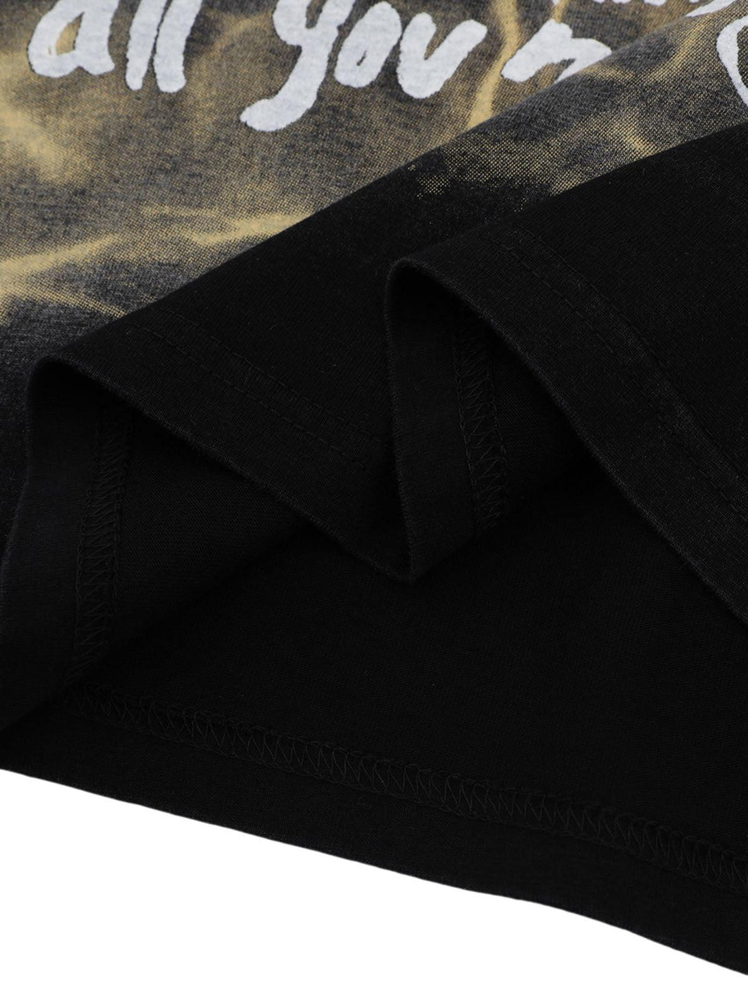 Detailed fabric and stitching on TALISHKO's oversized letter graphic T-shirt in black.