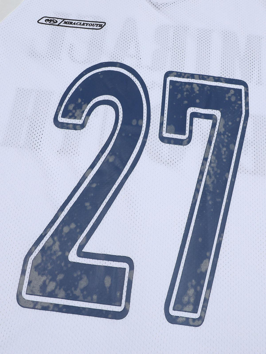 A detailed view of the number 27 on a white sports jersey by TALISHKO, showcasing texture.