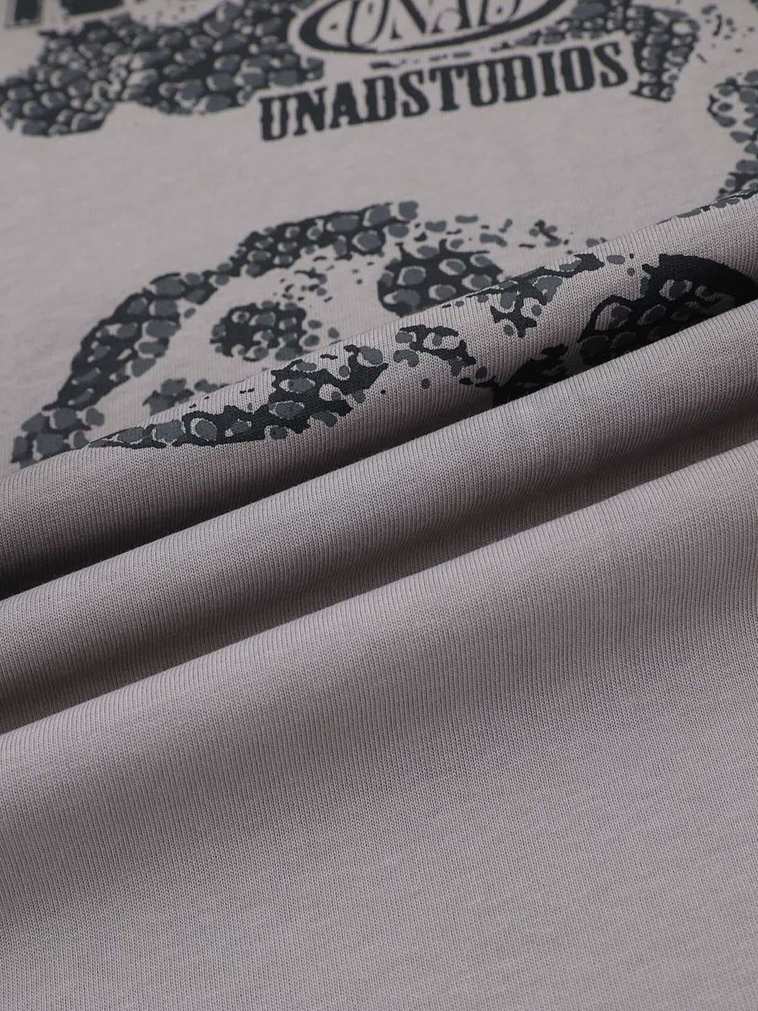 Intricate look at the snake graphic and fabric texture on a T-shirt by TALISHKO.