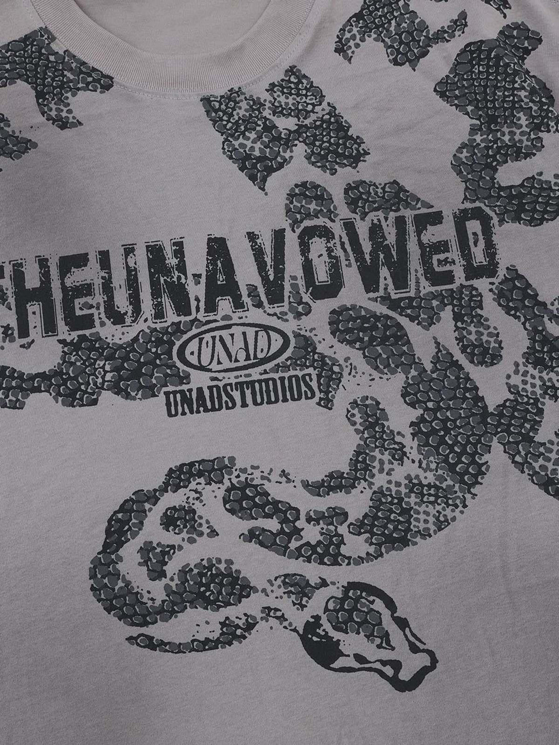 Zoomed-in texture of the snake graphic on an oversized T-shirt by TALISHKO, featuring bold design.