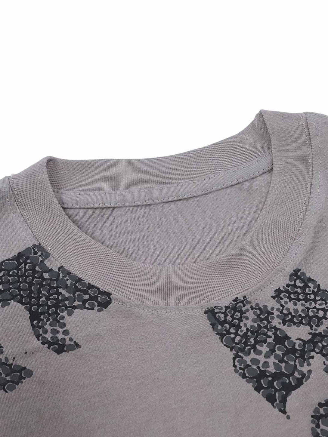 A detailed view of the neckline and snake graphic pattern on a T-shirt by TALISHKO.