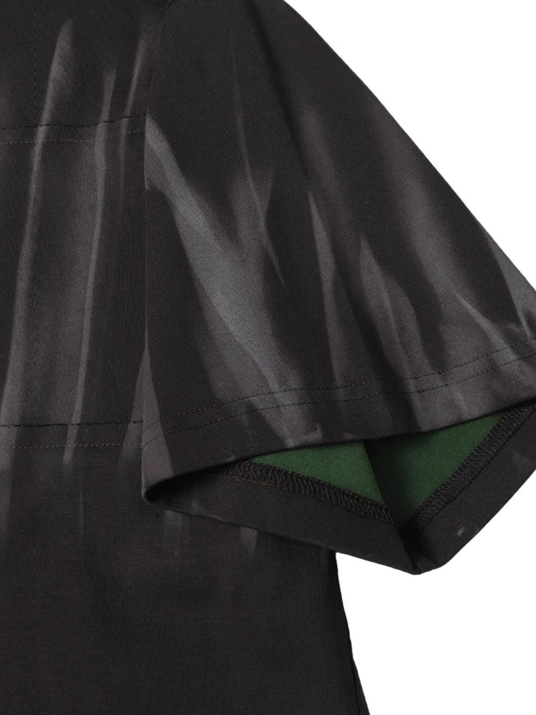 A detailed look at the sleeve of a TALISHKO oversized tie-dye T-shirt, showcasing fabric texture.