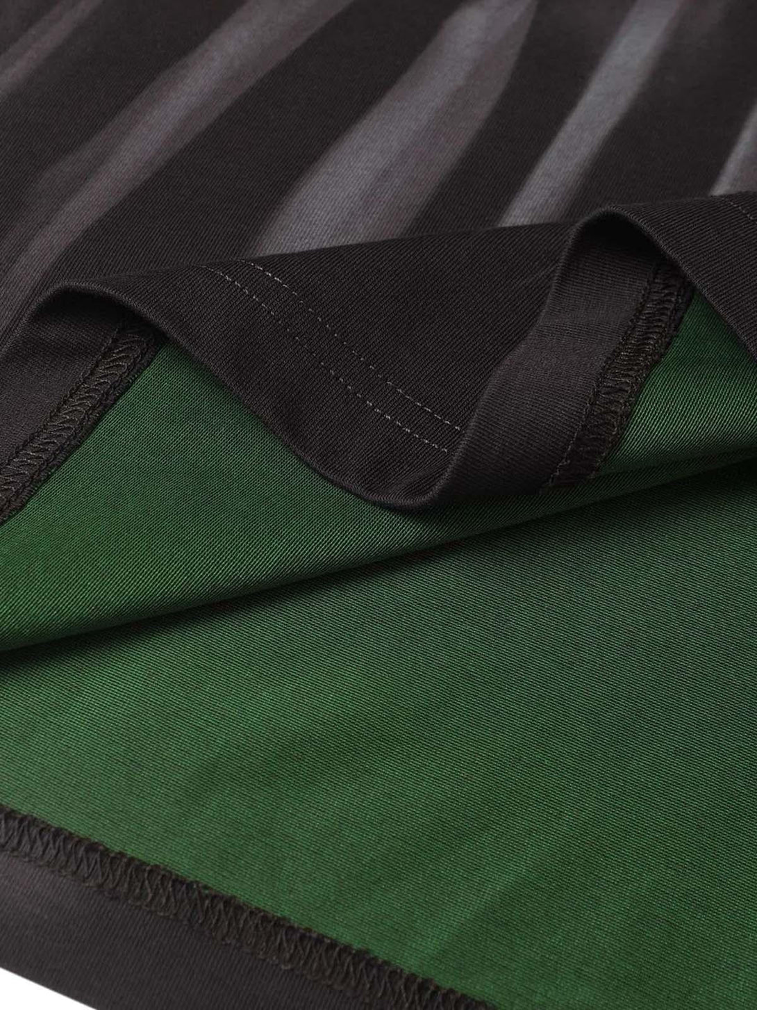 Focusing on the intricate stitching and fabric contrast of a TALISHKO oversized T-shirt.