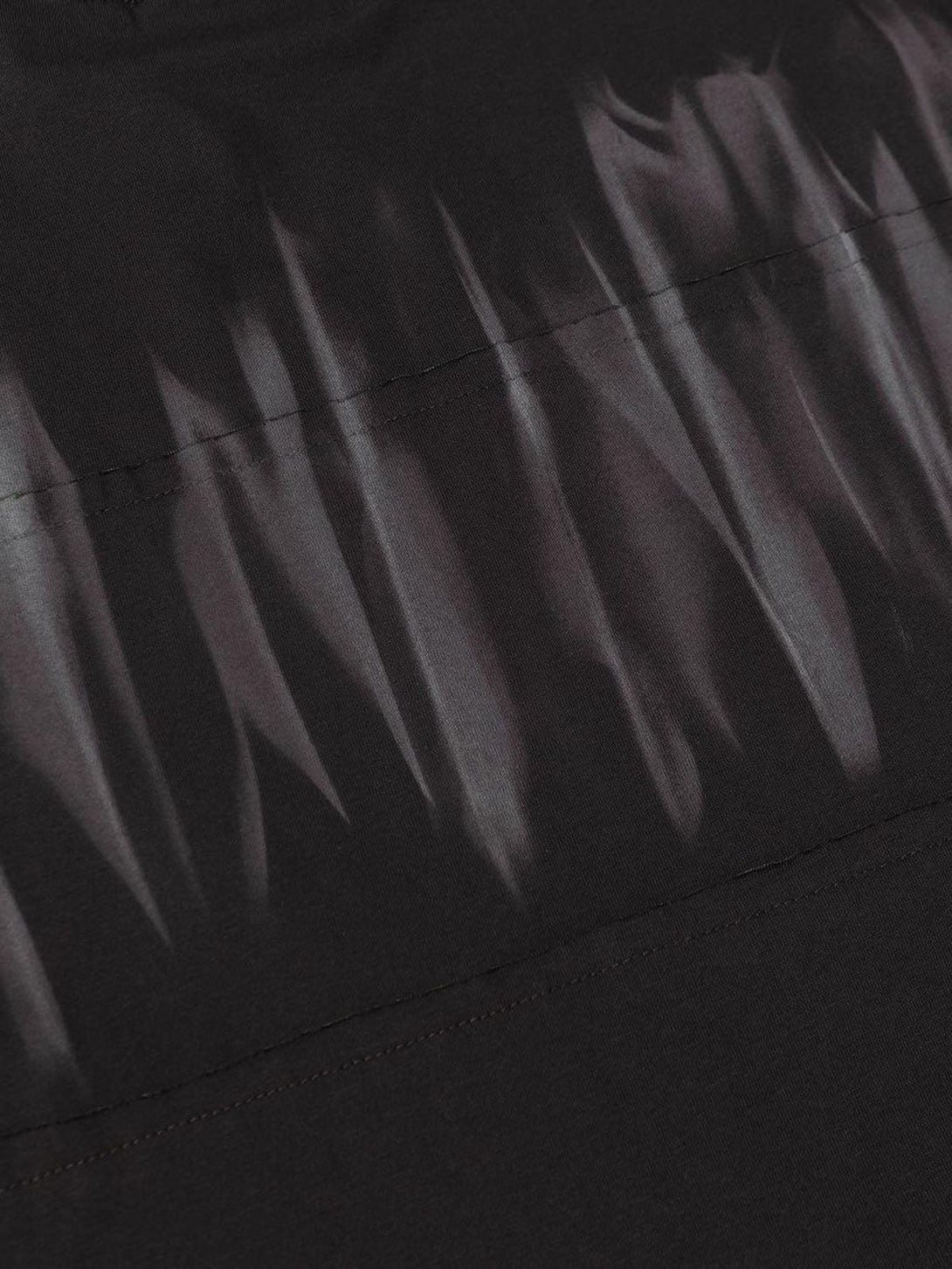 Intricate look at the tie-dye texture on a TALISHKO T-shirt, highlighting unique design details.